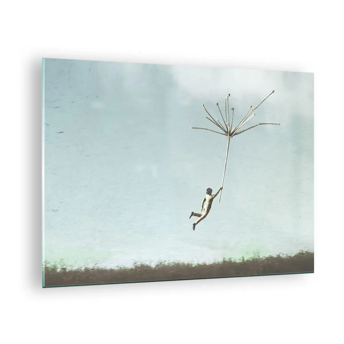 Tablou pe sticlă - Un băiat zboară cu o sămânță de păpădie peste o pajiște - 70x50cm - Zmeuri, suflante, vânt - Decorațiune modernă pentru perete pentru living și dormitor ARTTOR
