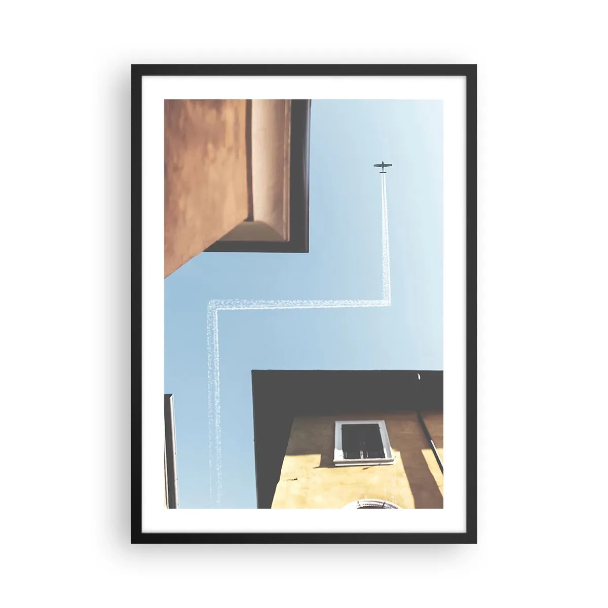 Poster în ramă neagră - Perspectiva clădirilor cu un avion și o cale neobișnuită pe cer - 50x70cm - Deasupra labirintului urban - Decorațiune modernă pentru perete pentru living și dormitor ARTTOR